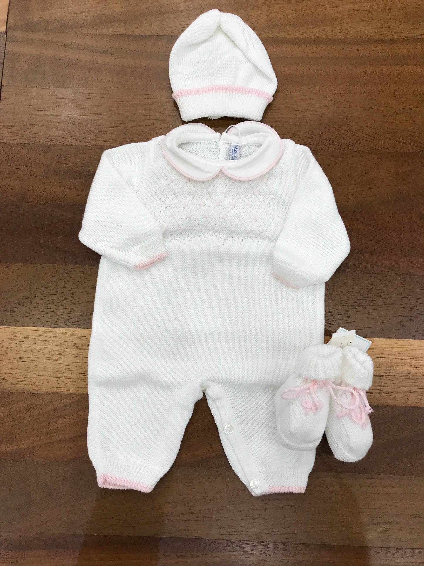 Tutina Bebè di Almy in filo con lavorazione di punto smock rosa con rifiniture in rosa