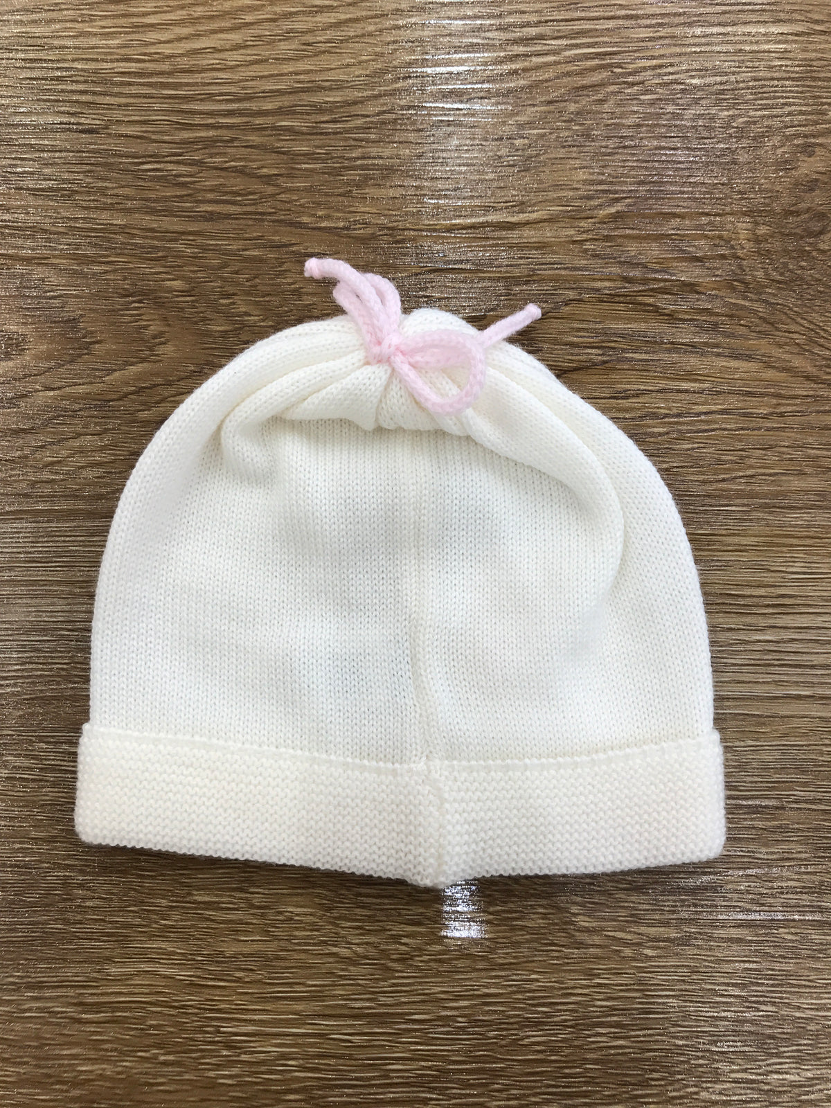 Cappello Baby Lord in lana panna con fiocchetto rosa