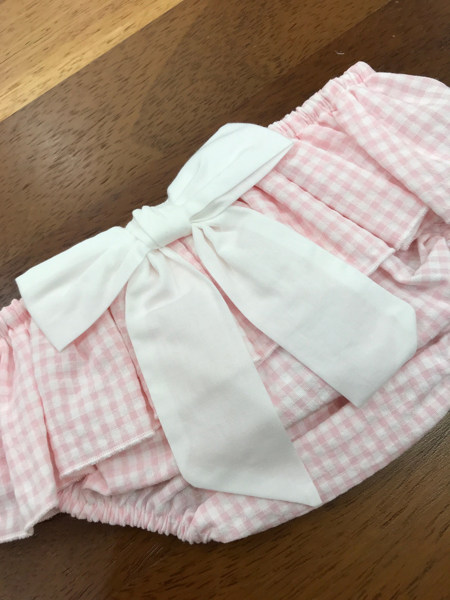 Culotte Baby Gi in cotone rosa a quadretti con rusche con fiocco bianco sul retro