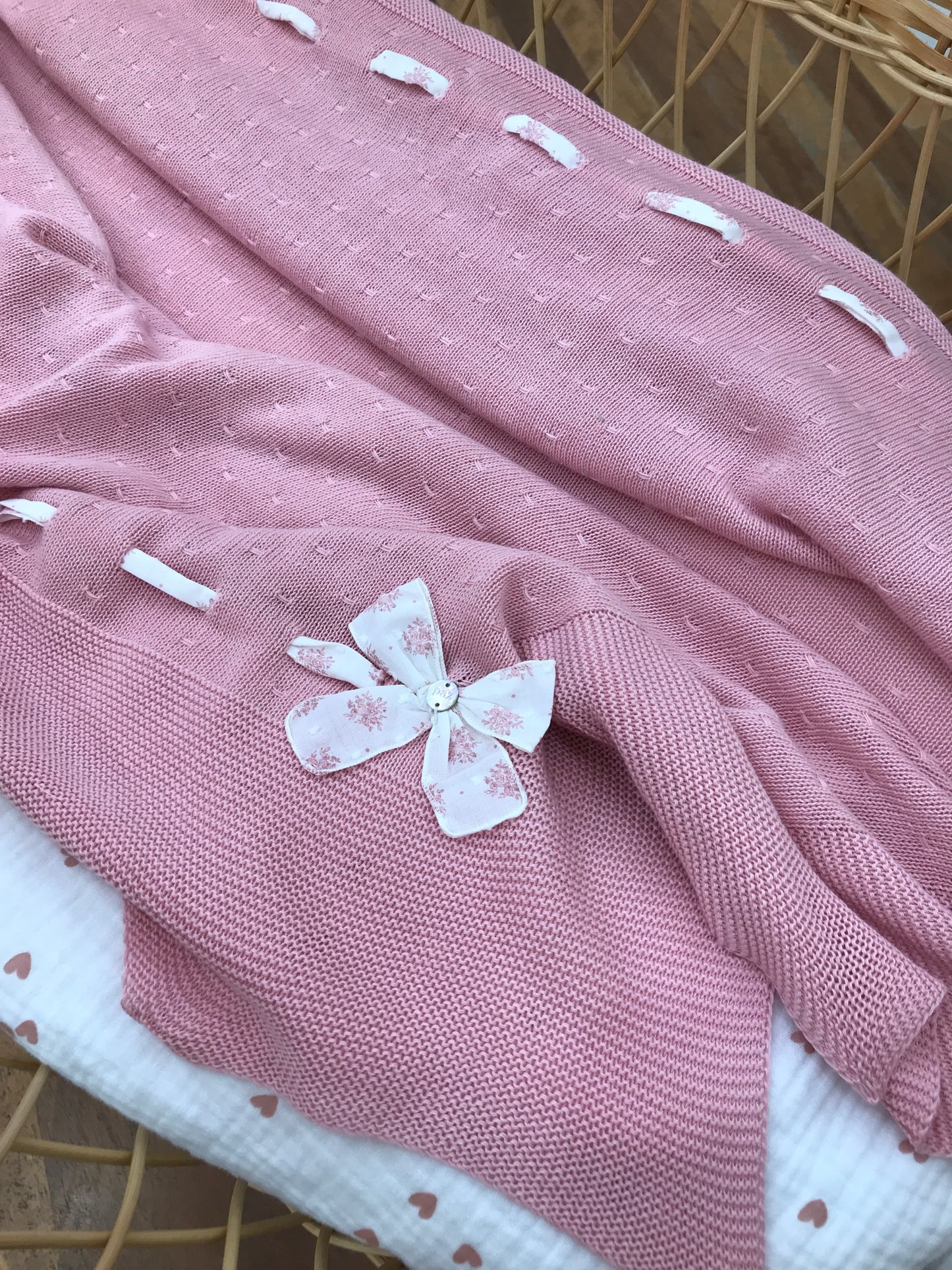 Coperta Paz Rodriguez in filo rosa smerlata al bordo con passanastro laterale in cotone bianco con fiori rosa con fiocchetto laterale