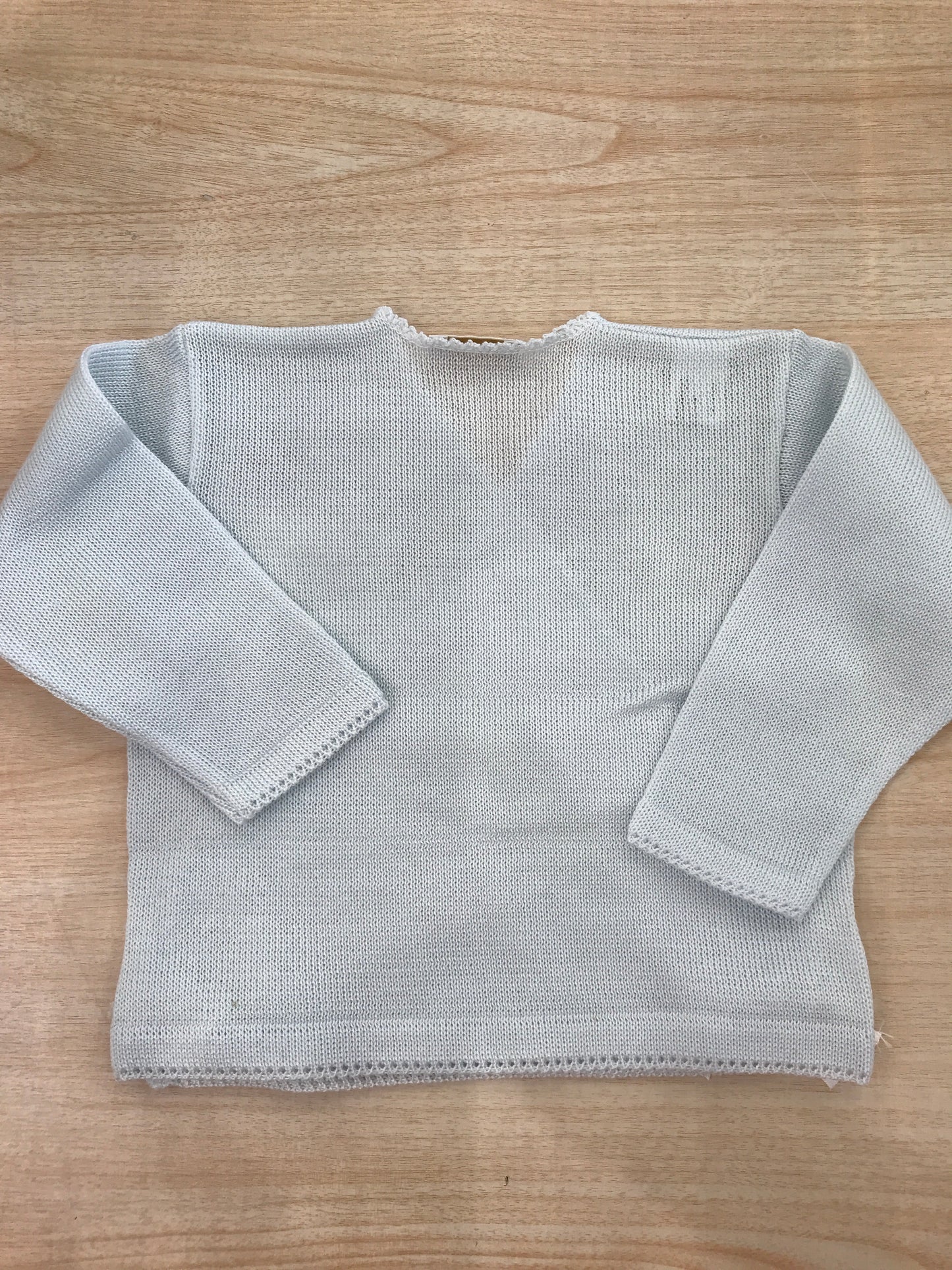Cardigan Baby Lord in filo celeste ad incrocio con fiocchetti bianchi