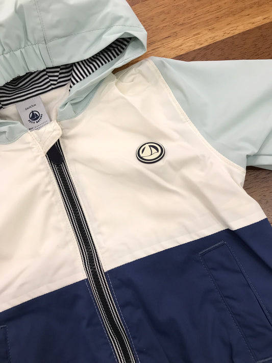 Giubbotto Petit Bateau impermeabile manica lunga con cappuccio in blu verde acqua e panna