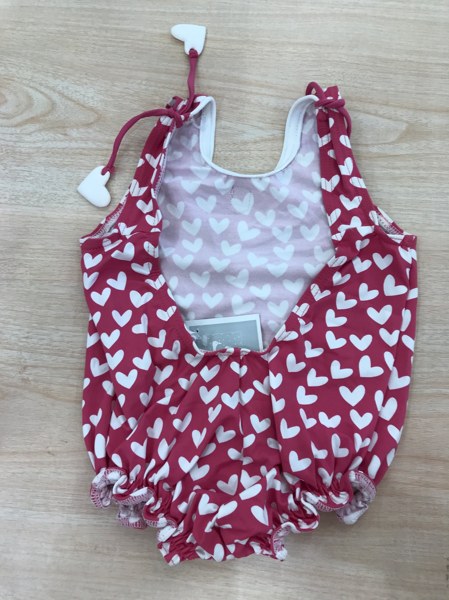 Costume Al Agua Patos intero fucsia a cuoricini bianchi e scollato sul retro