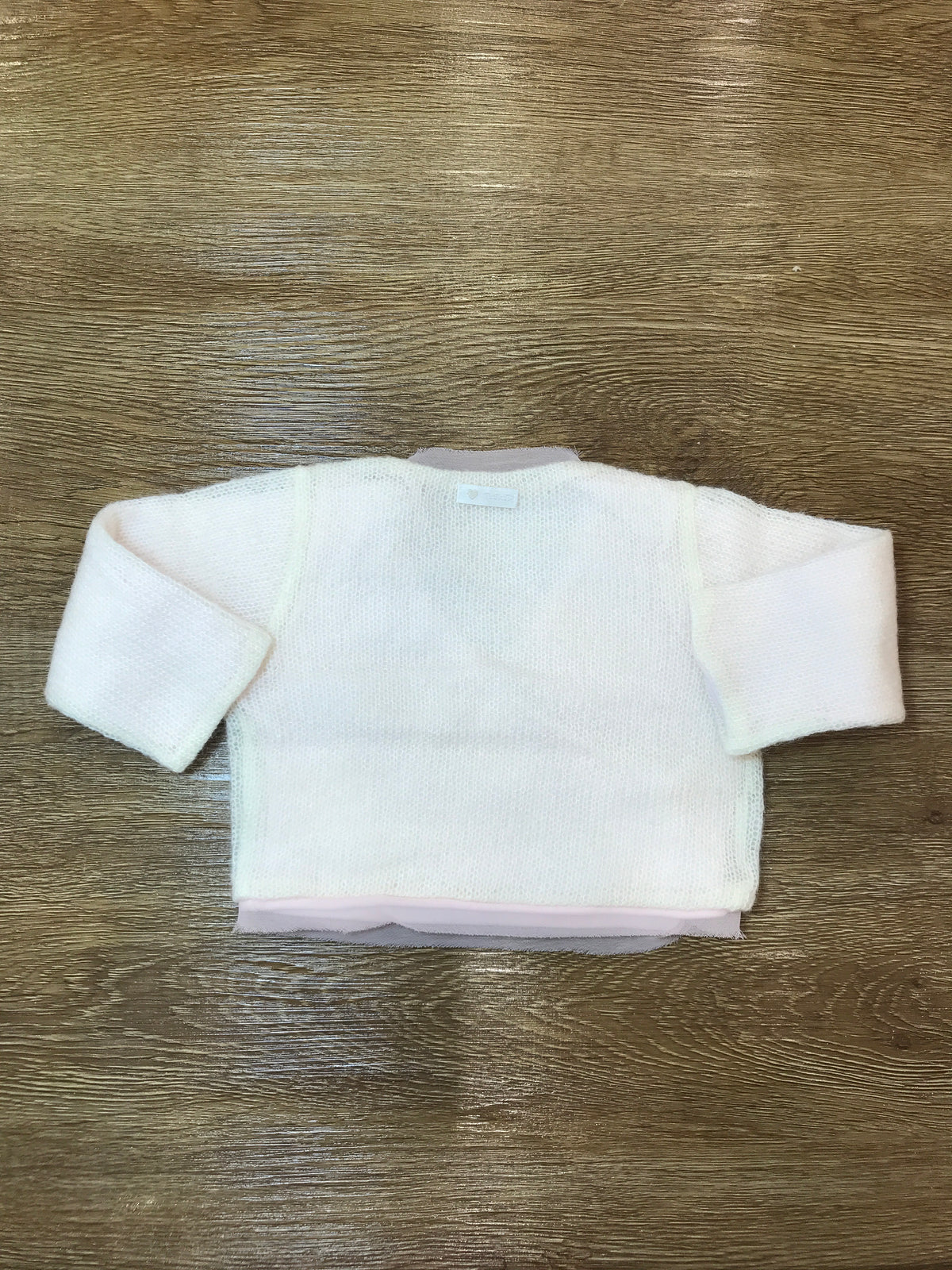 Cardigan Nanan in lana panna con tulle rosa incrociatina con piccoli bottoncini