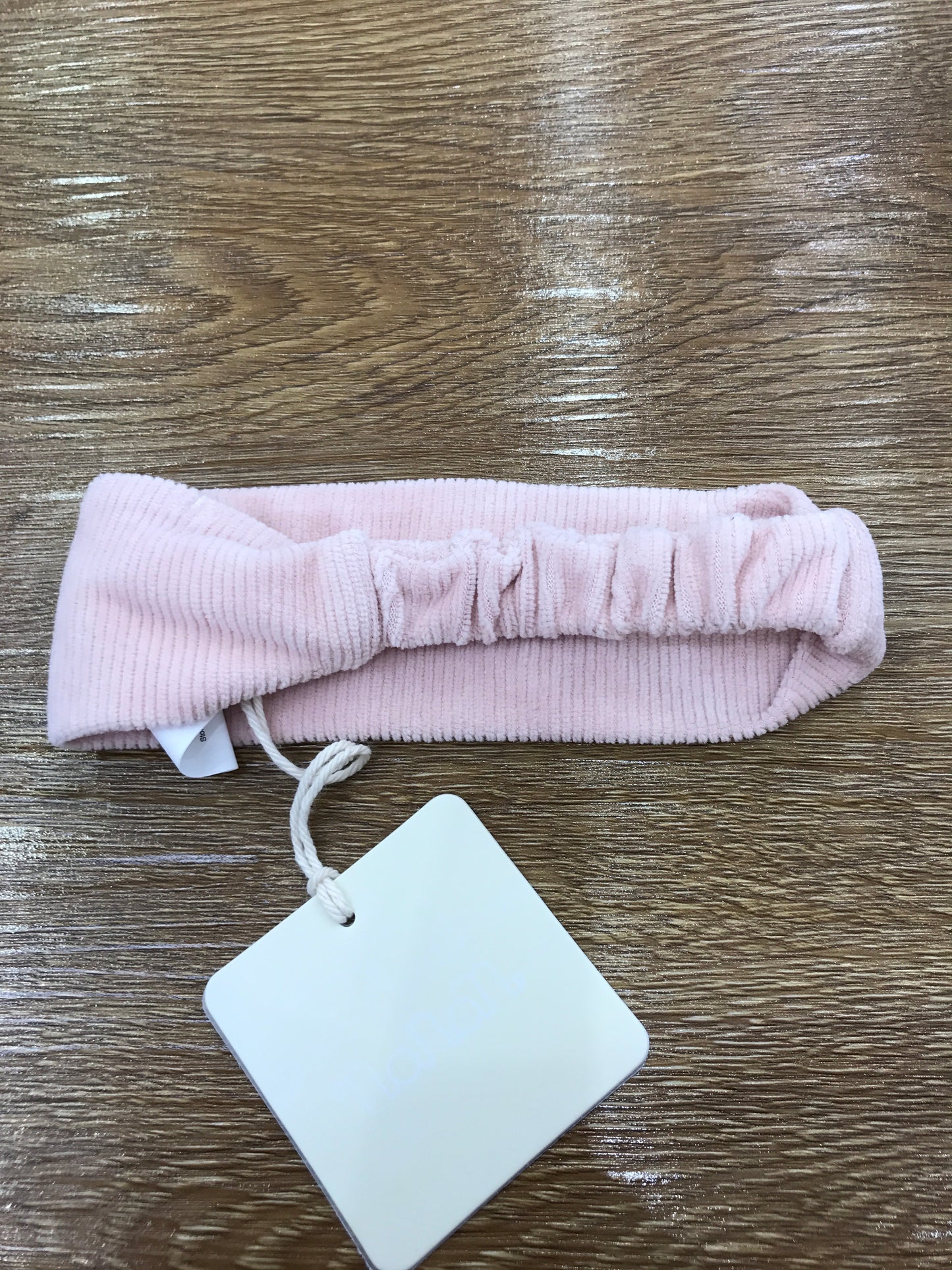 Fascia Nanan in ciniglia a costine con elastico sul retro e fiocchetti sul davanti