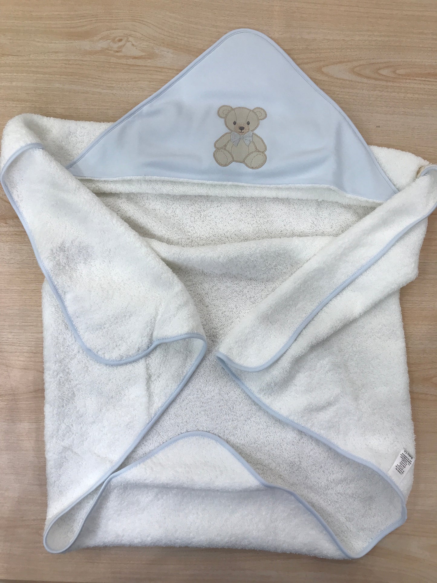 Telo Bagnetto Baby Gi in spugna con bordo celeste con triangolo celeste con orsetto ricamato con fiocchetti grigio
