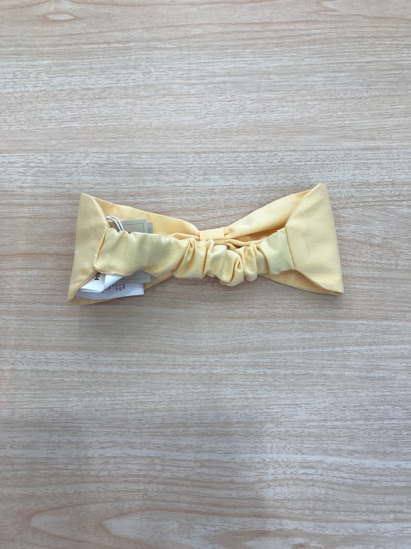 Fascia Le Bebè in cotone giallo a forma di fiocco con elastico sul retro