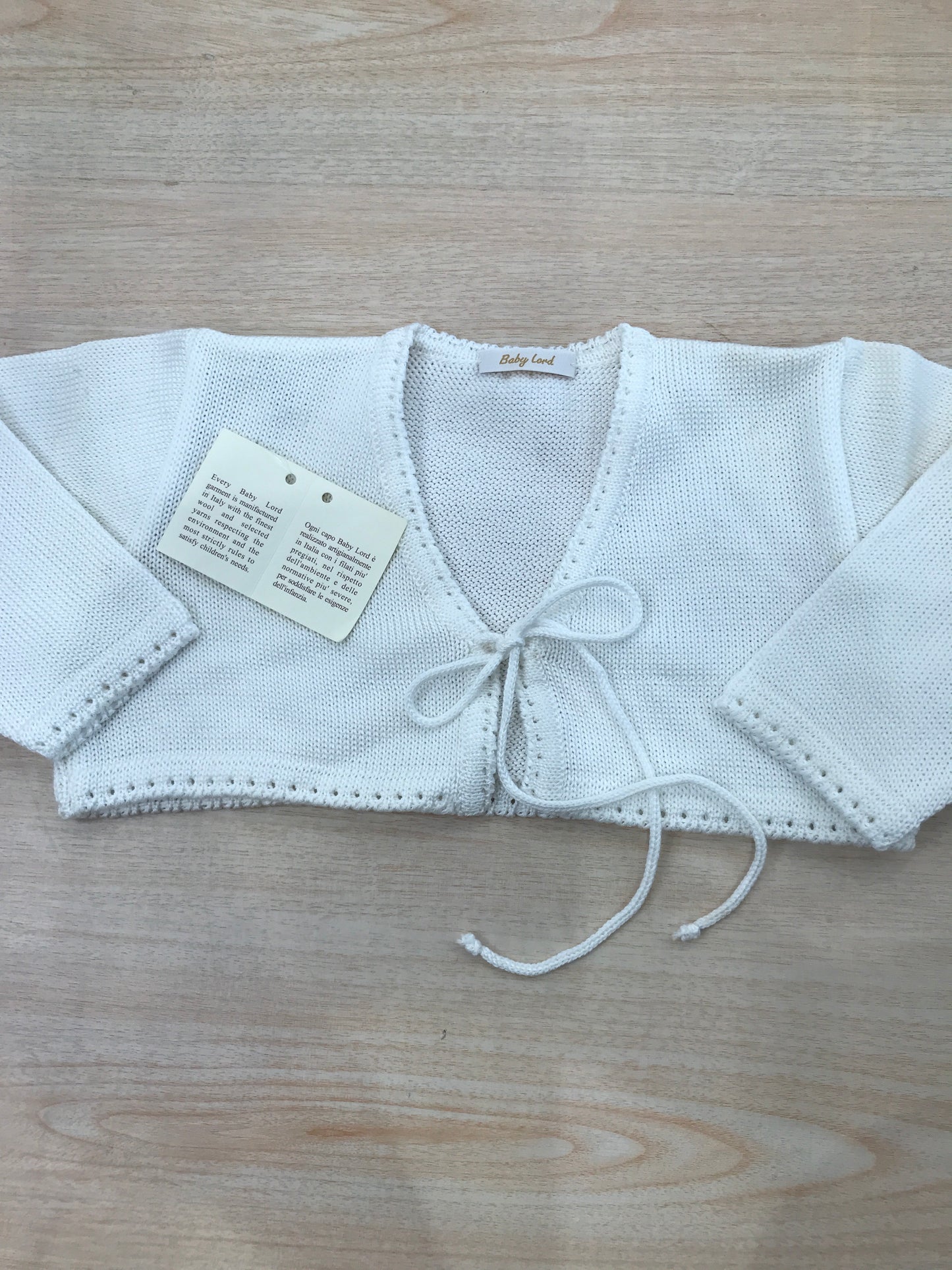 Cardigan Baby Lord in filo panna con lacci per fiocco