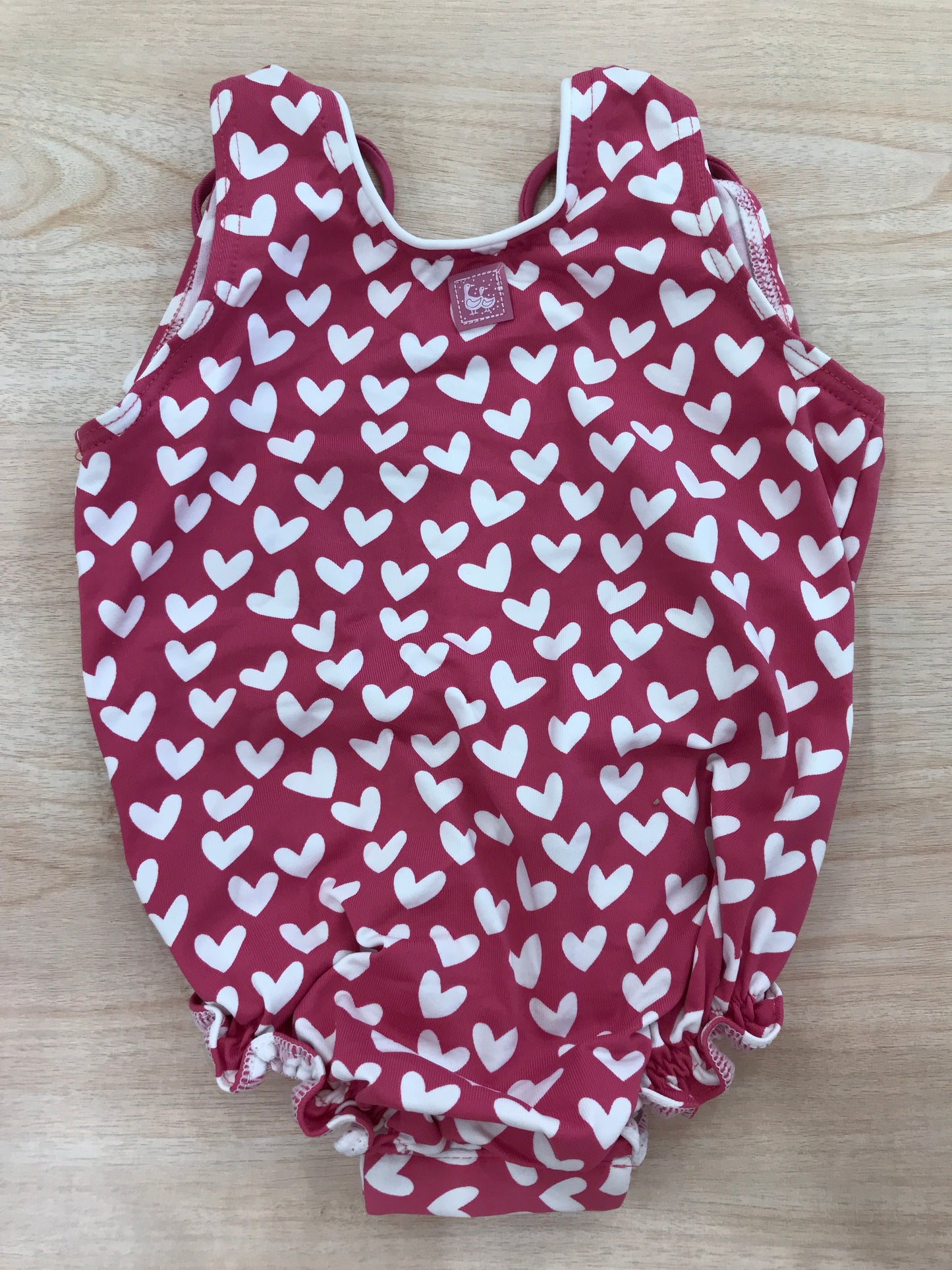 Costume Al Agua Patos intero fucsia a cuoricini bianchi e scollato sul retro