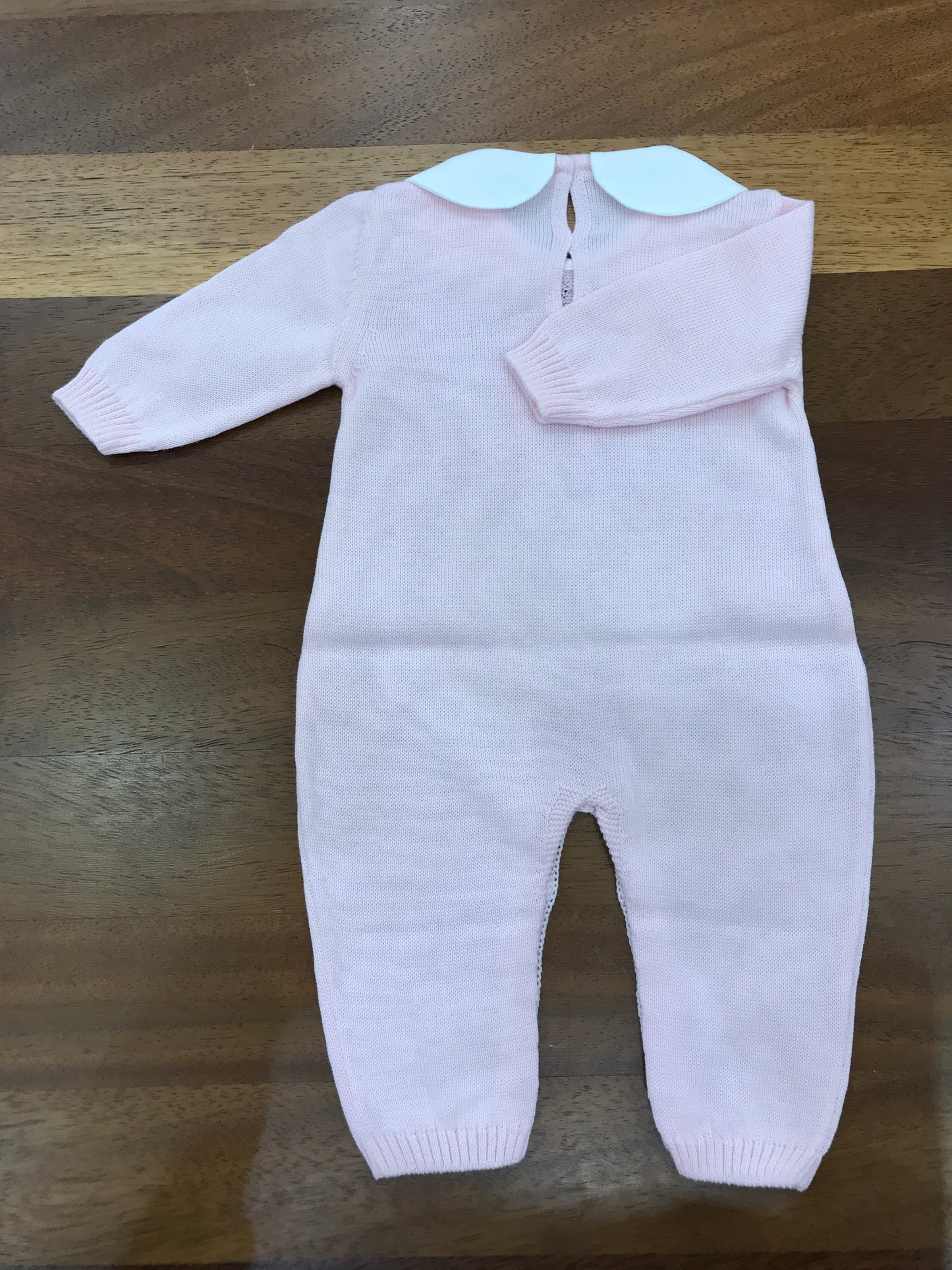 Tutina Baby Lord in filo rosa manica lunga con lavorazione id trecce sul davanti con collo tondo
