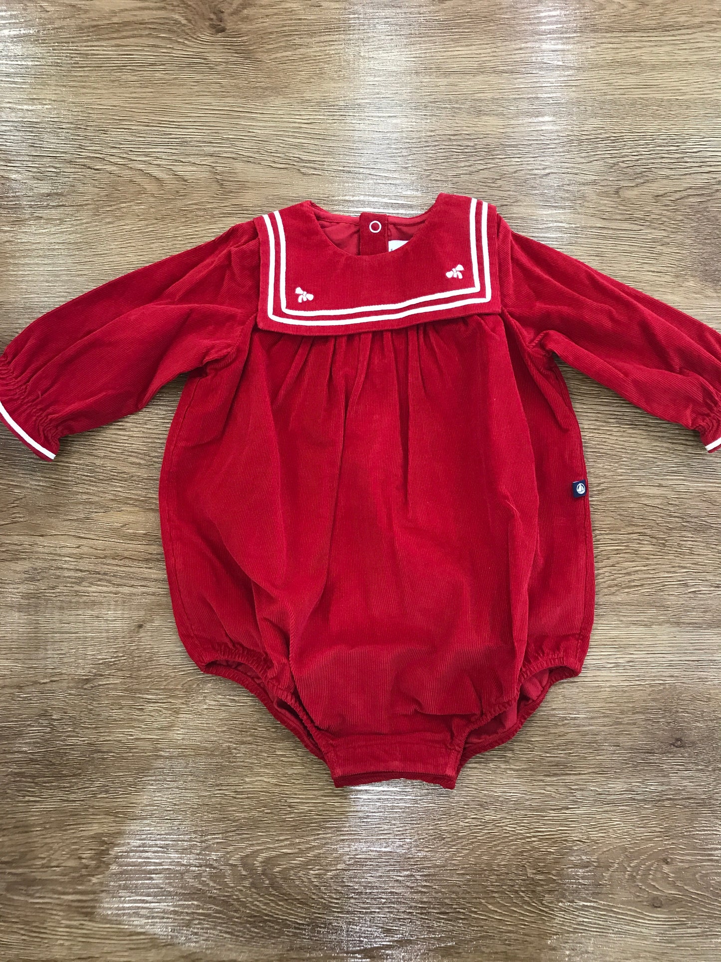 Pagliaccetto Petit Bateau a costine rosso con manica a sbuffo con collo squadrato con piccoli fiocchetti bianchi