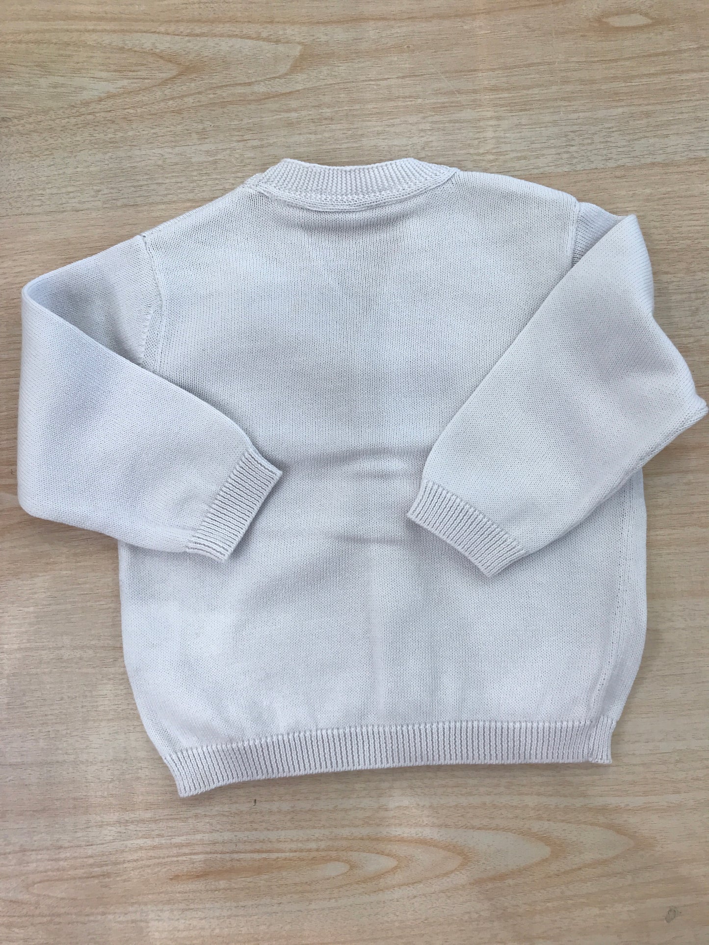 Cardigan Coccodè in filo bianco con scollo a punta e piccoli bottoncini sul davanti