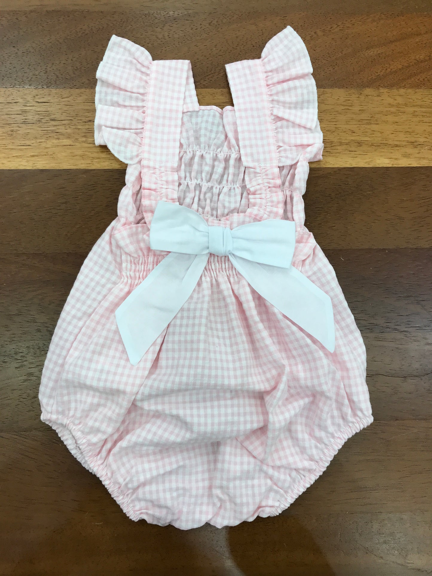 Pagliaccetto Baby Gi in cotone fantasia a quadretti con spalline con rusche con fiocco sul retro
