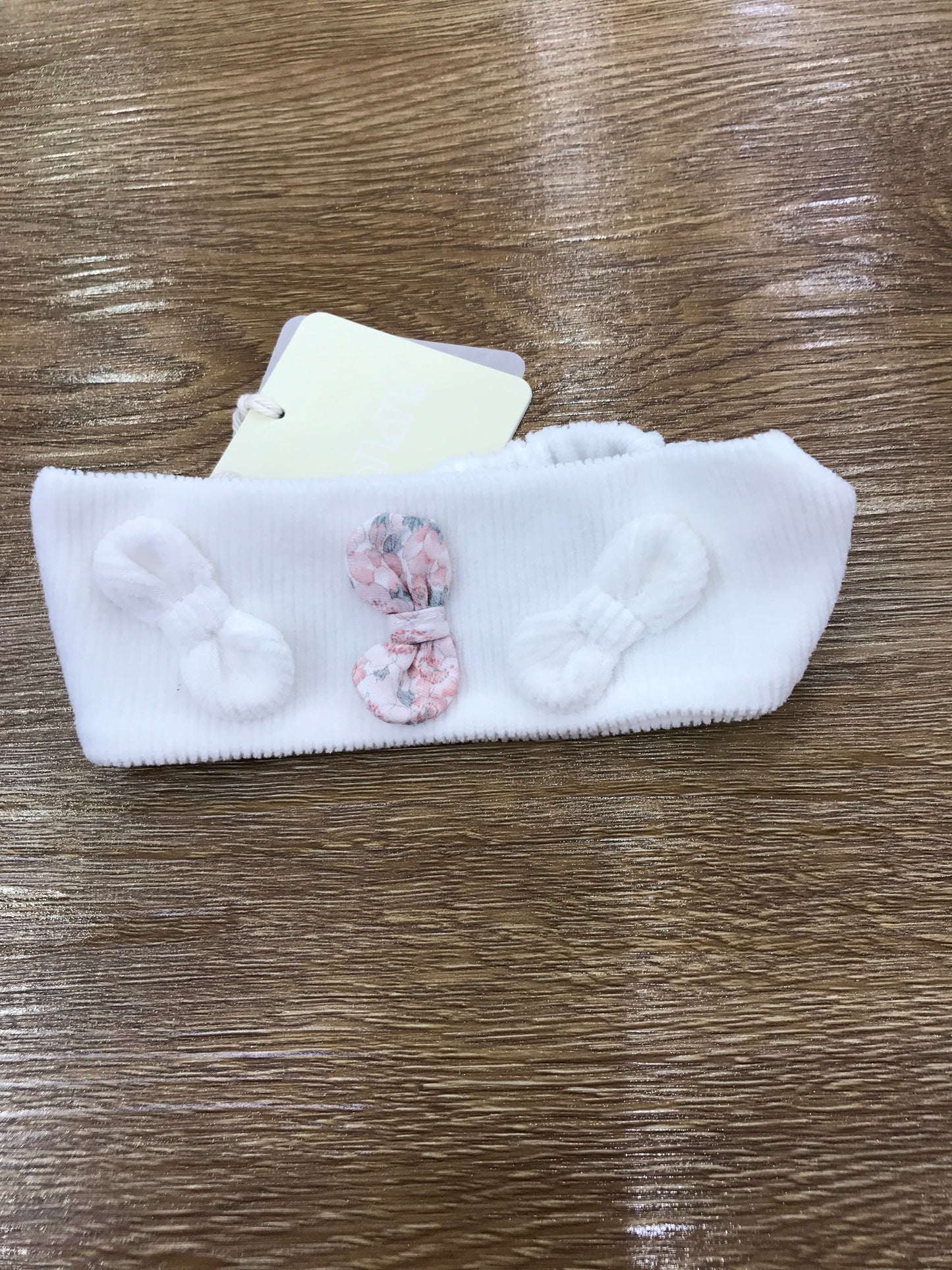 Fascia Nanan in ciniglia a costine bianca con elastico sul retro e fiocchetti sul davanti