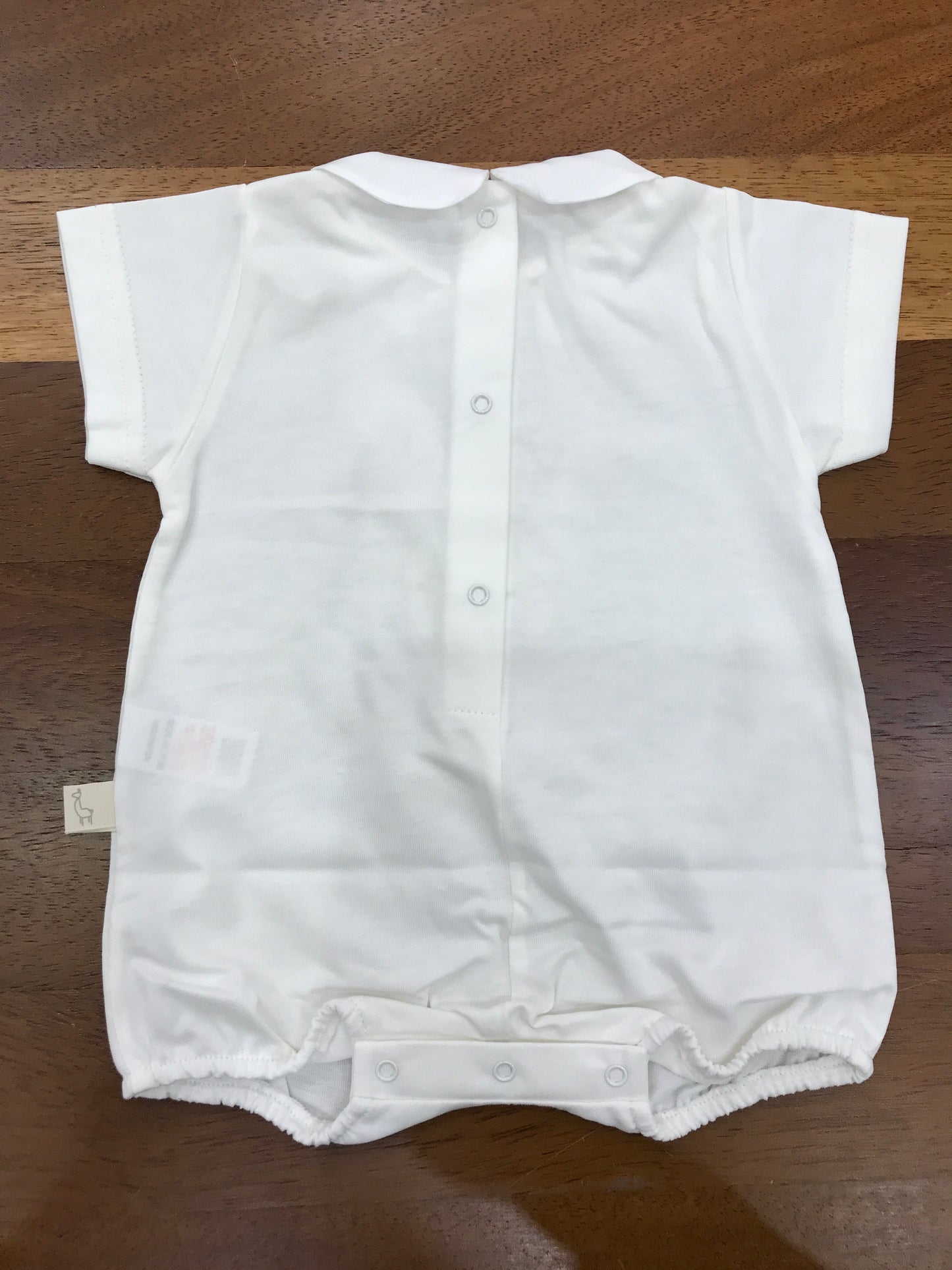 Pagliaccetto Baby Gi in cotone panna corto mezza manica con collo tondo con orsetto centrale sul davanti con fiocchetto