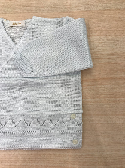 Cardigan Baby Lord in filo celeste chiaro ad incrocio con lavorazioni in basso