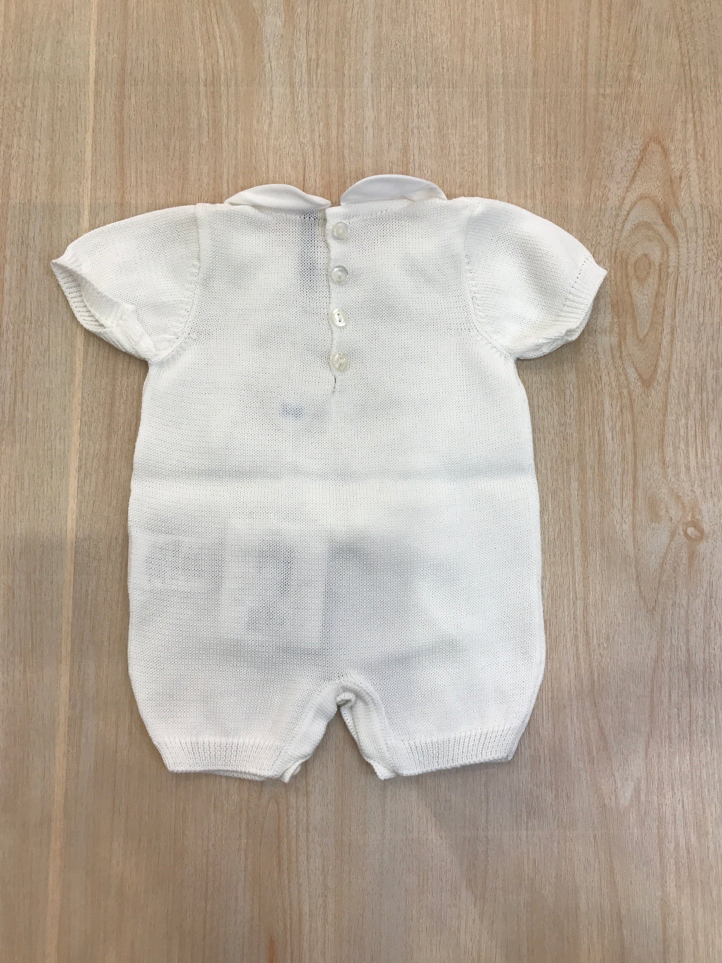 Pagliaccetto Bebè di Almy in filo bianco mezza manica collo tondo con pizzo e fiocco applicato sul davanti