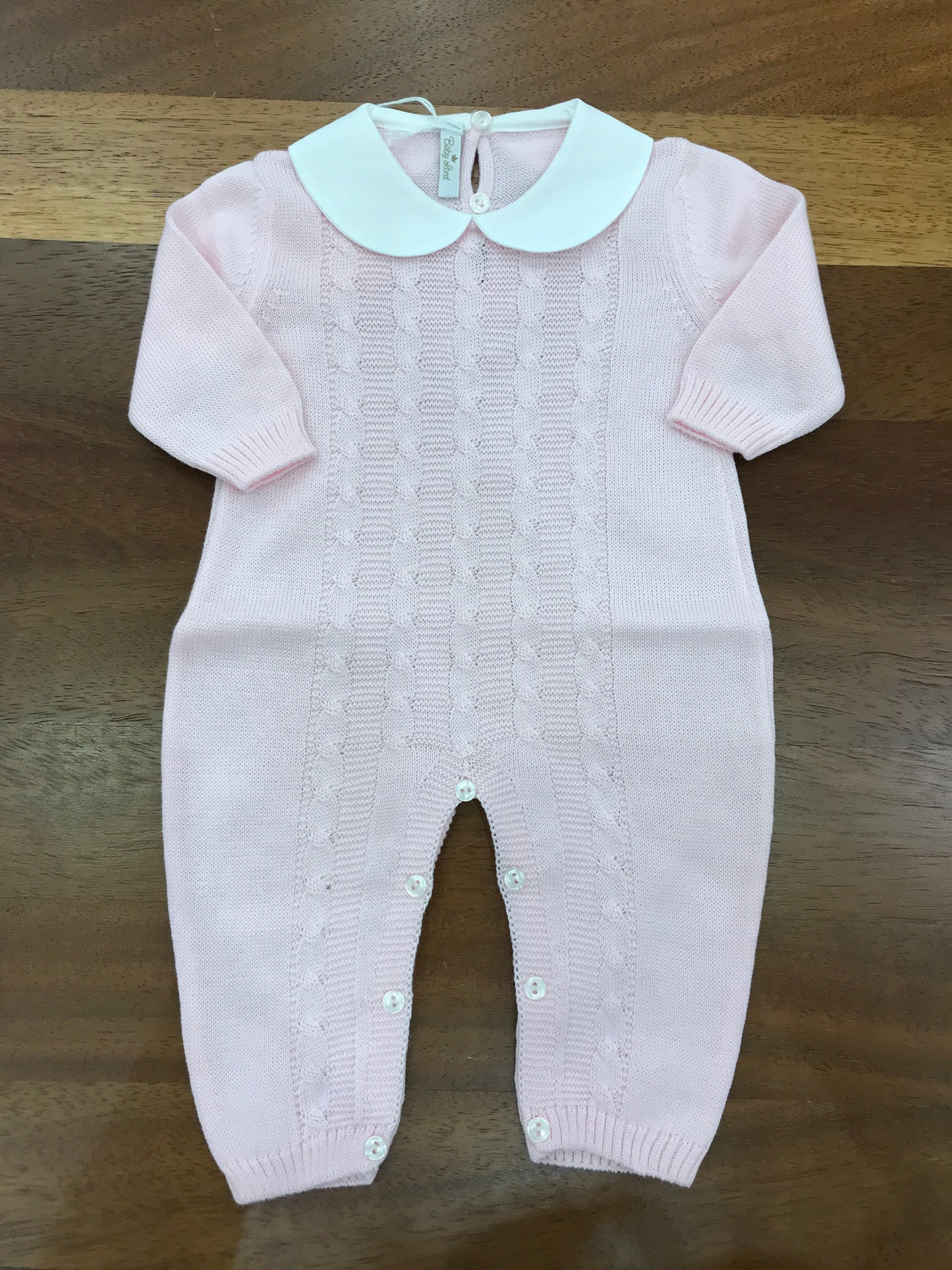 Tutina Baby Lord in filo rosa manica lunga con lavorazione id trecce sul davanti con collo tondo