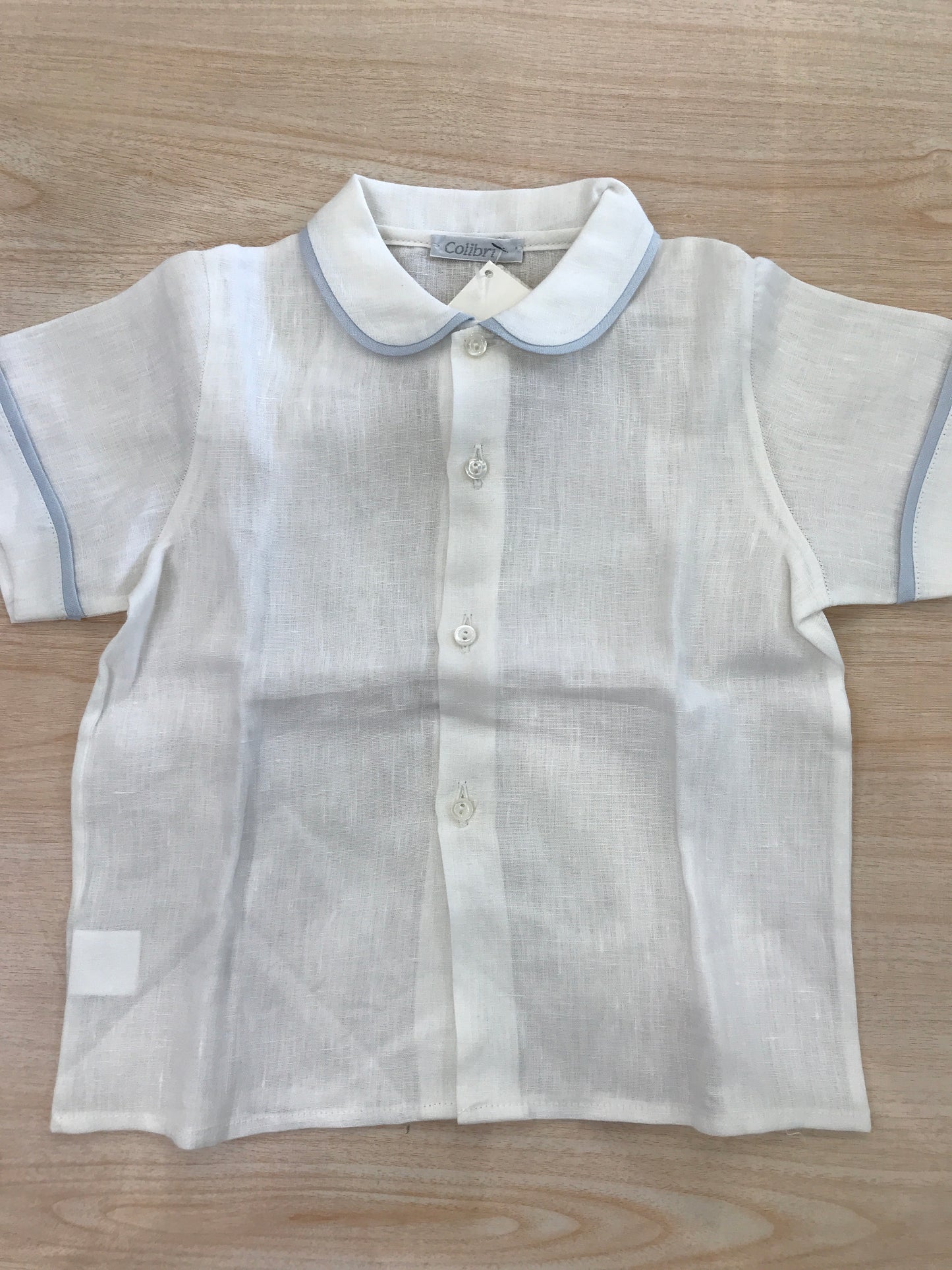 Camicia Colibrì in lino mezza manica con profilo celeste con bottoncini sul davanti