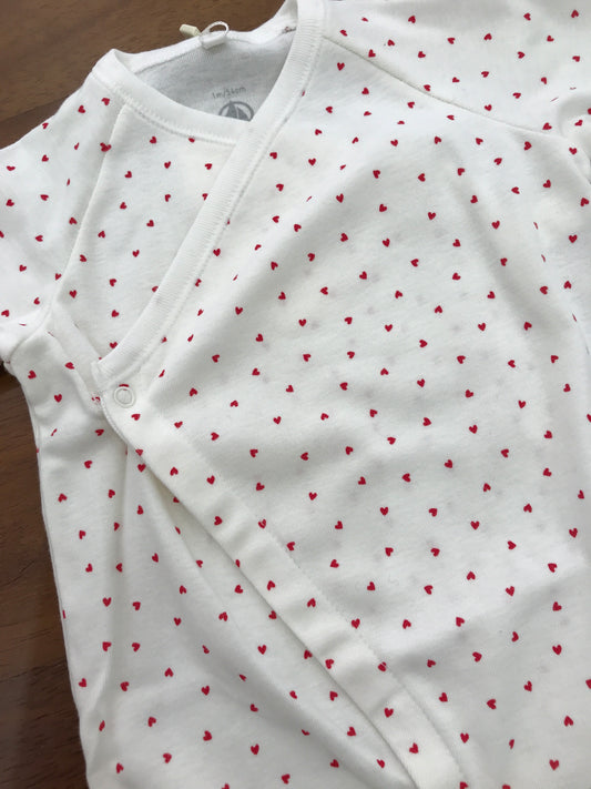 Tutina Petit Bateau di cotone antipanico bianca con piccoli cuori rossi