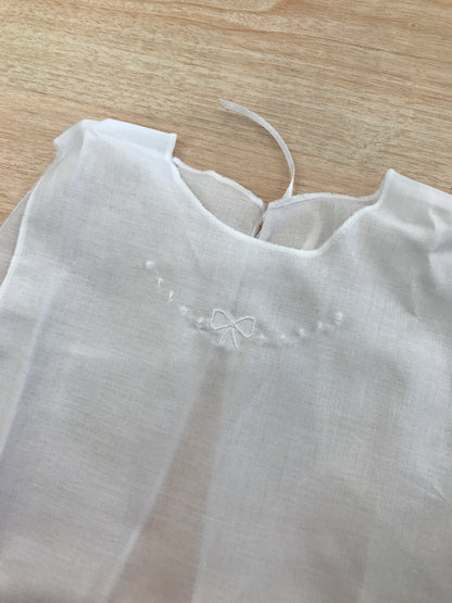 Camicino Baby gi in cotone bianco smanicato con pois e fiocchetto bianco ricamato sul davanti