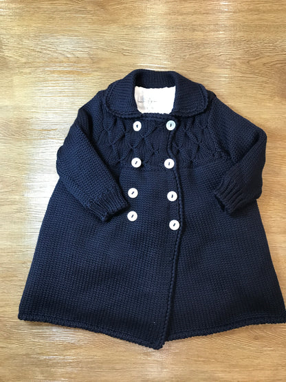Cappotto Colibrì in lana foderato con piccoli bottoncini doppiopetto e lavorazione di punto smock