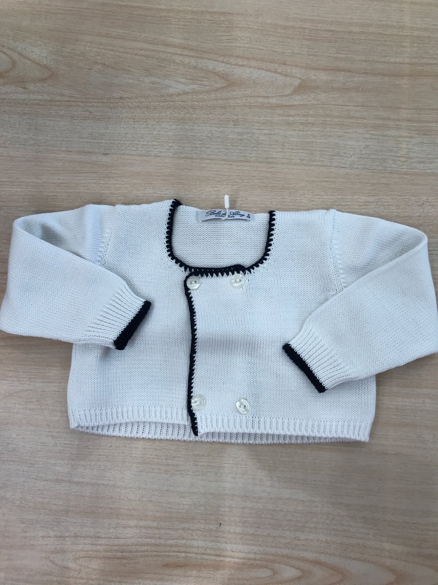 Cardigan Bebè di Almy in filo bianco con rifiniture blu scuro e bottoncini