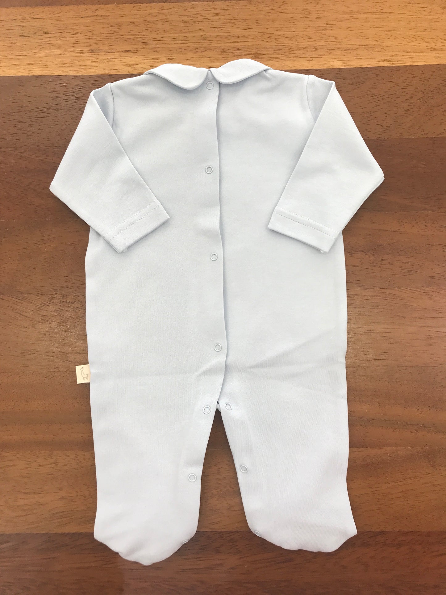 Tutina Baby Gi in cotone color carta da zucchero manica lunga con piedini collo tondo con mongolfiera e nuvolette ricamate sul davanti