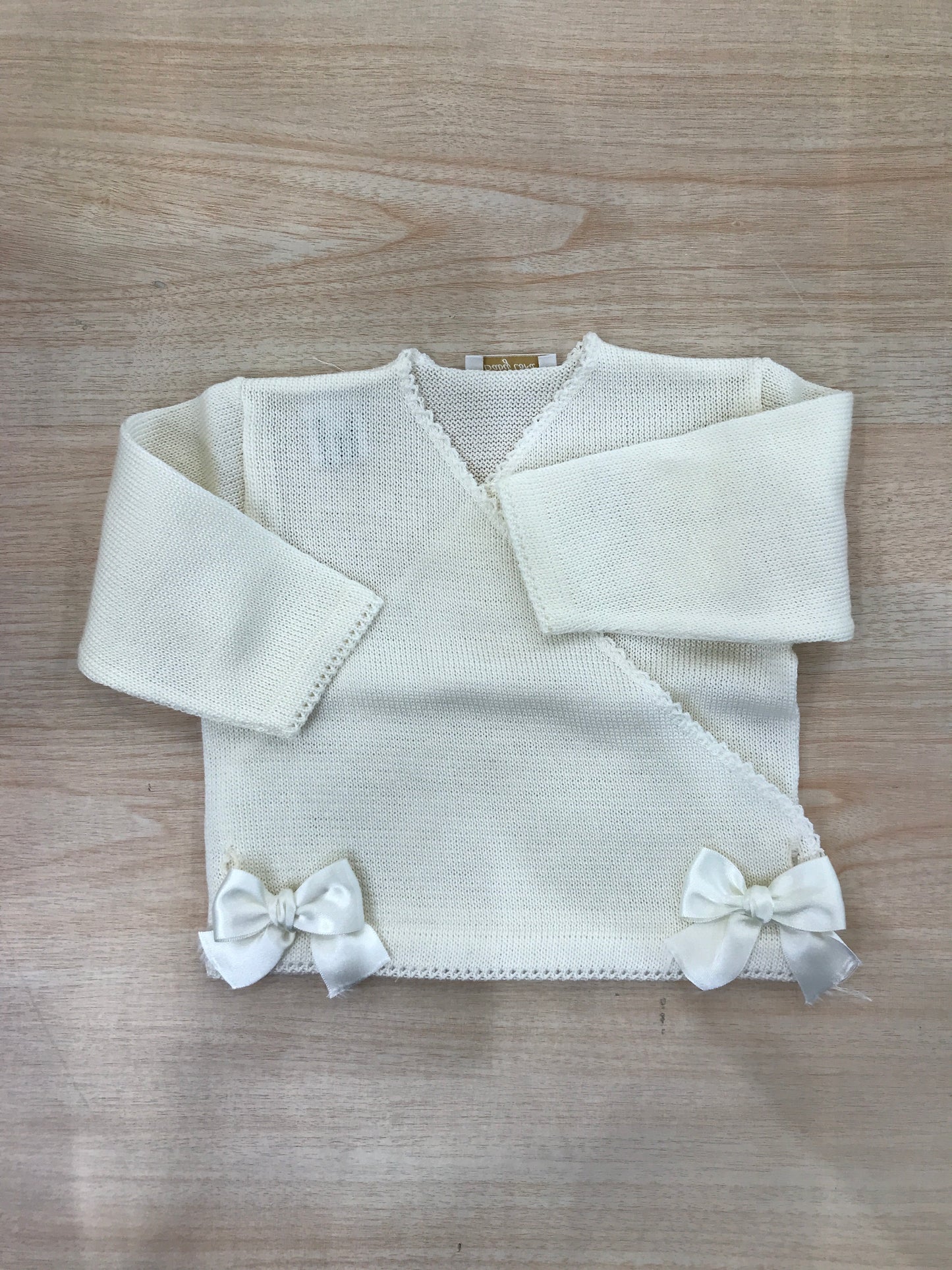 Cardigan Baby Lord in filo panna con chiusura ad incrocio e fiocchetti