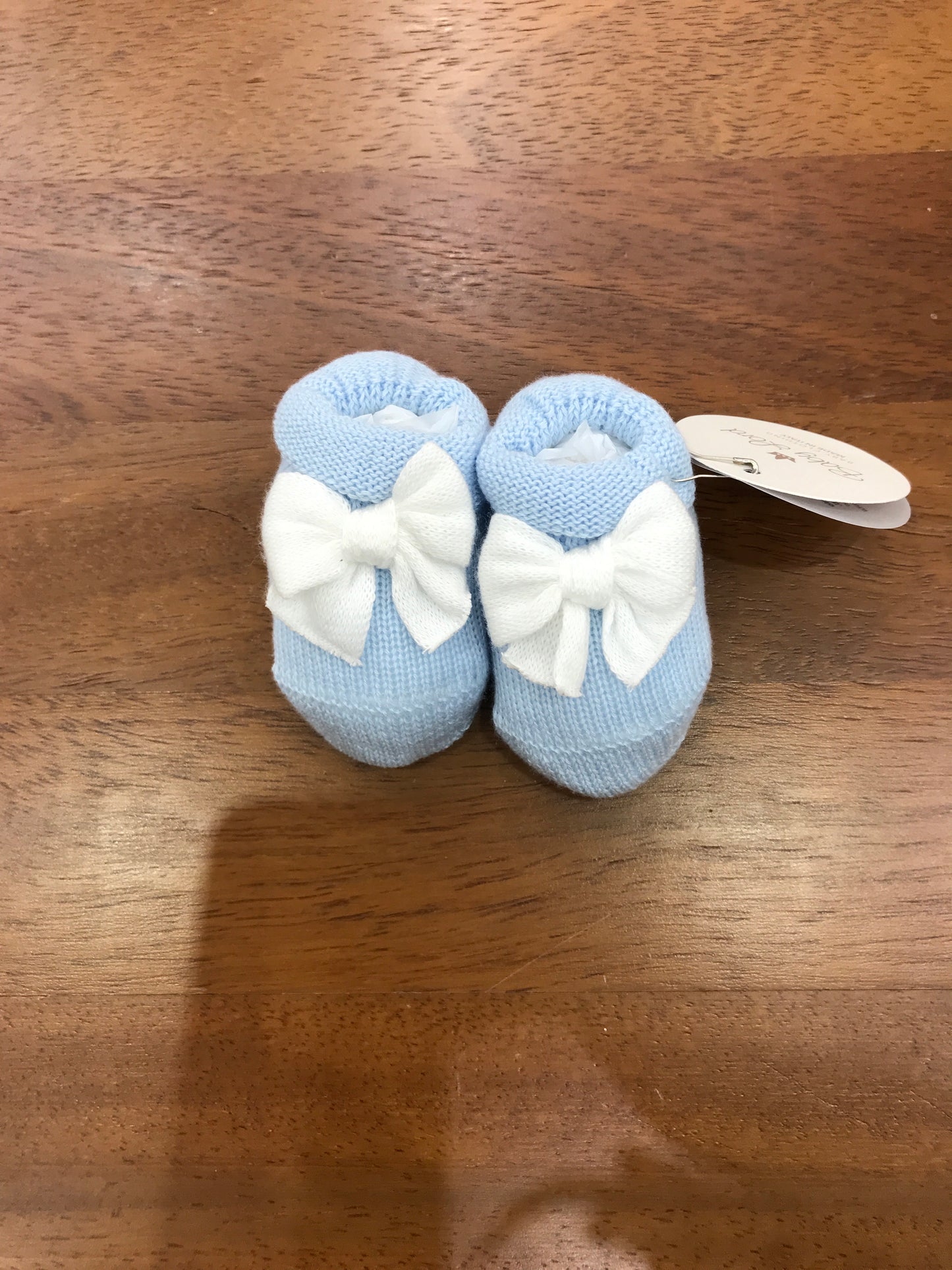 Babbucce Baby Lord in filo celesti con risvolto con fiocco bianco sul davanti