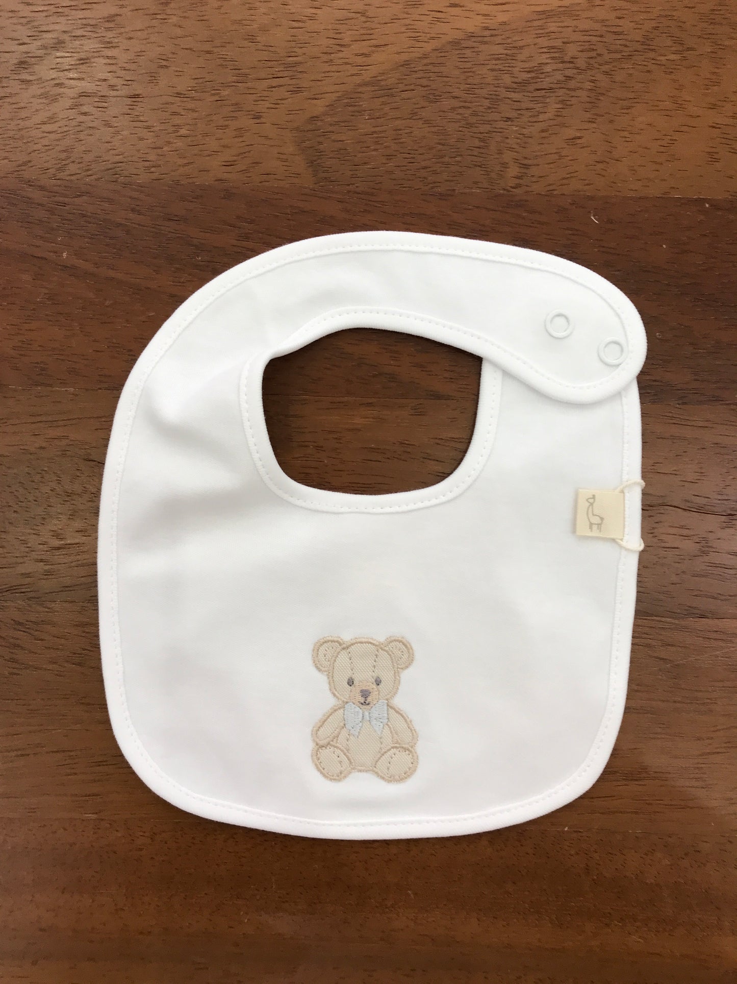 Bavetta Baby Gi in cotone bianco con orsetto ricamato sul davanti con fiocco grigio