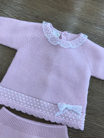 Tutina PCS in lana rosa due pezzi con piedini con applicazione id valancienne e piccolo fiocchetto