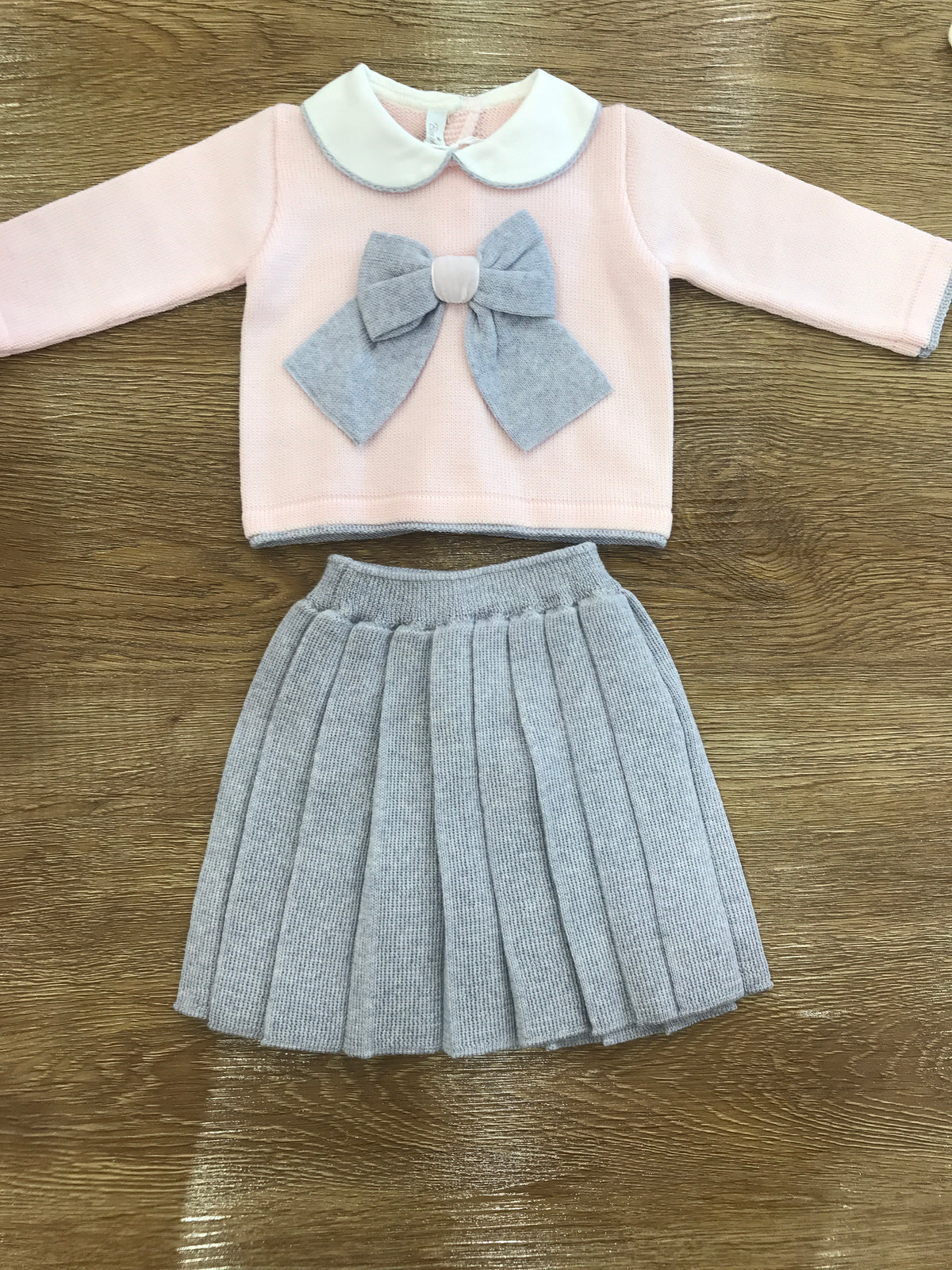 Tutina Baby Lord in lana due pezzi rosa con fiocco grigio gonna grigia plissettata