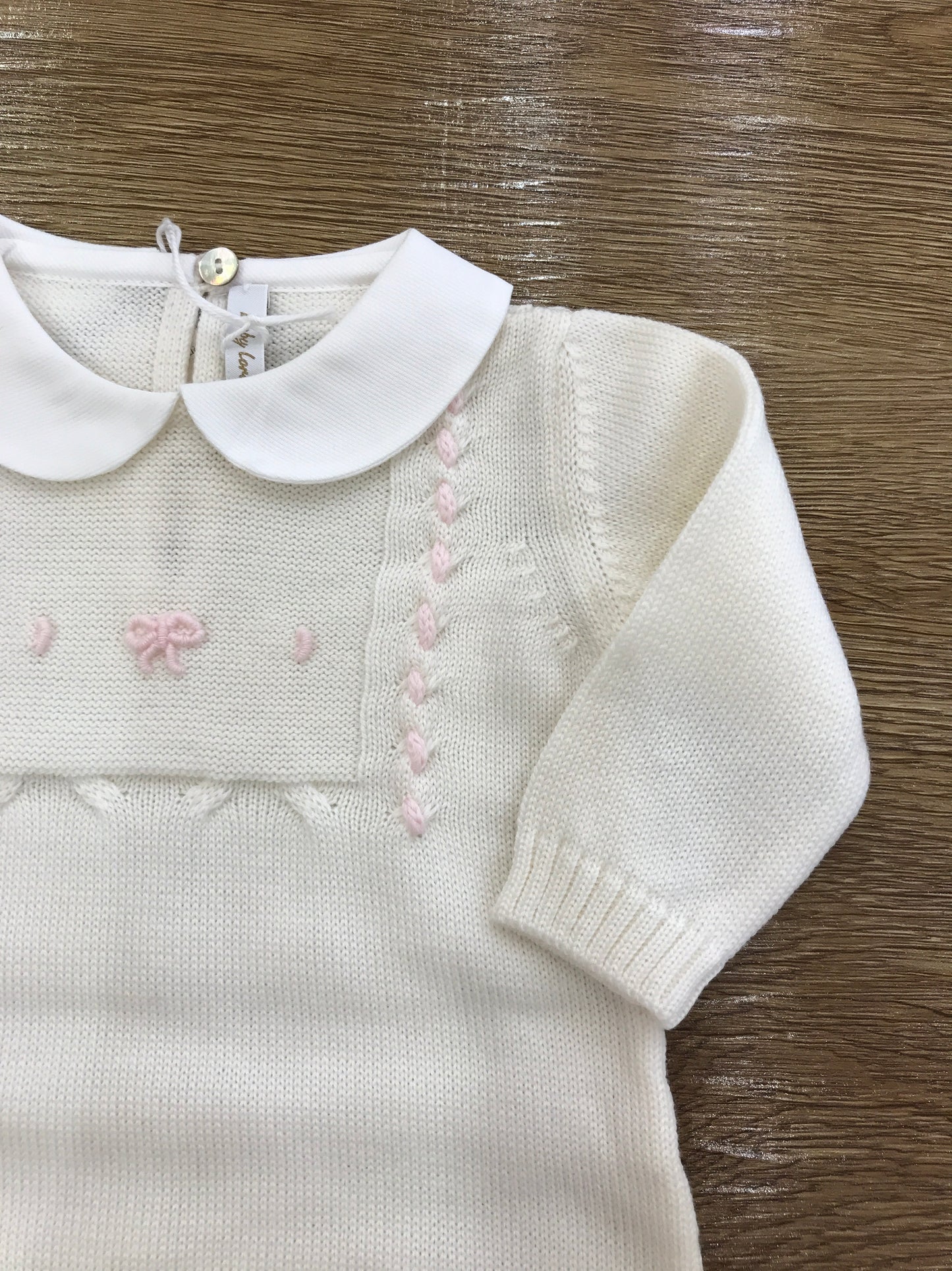 Tutina Baby Lord in lana panna con fiocchetto rosa ricamato