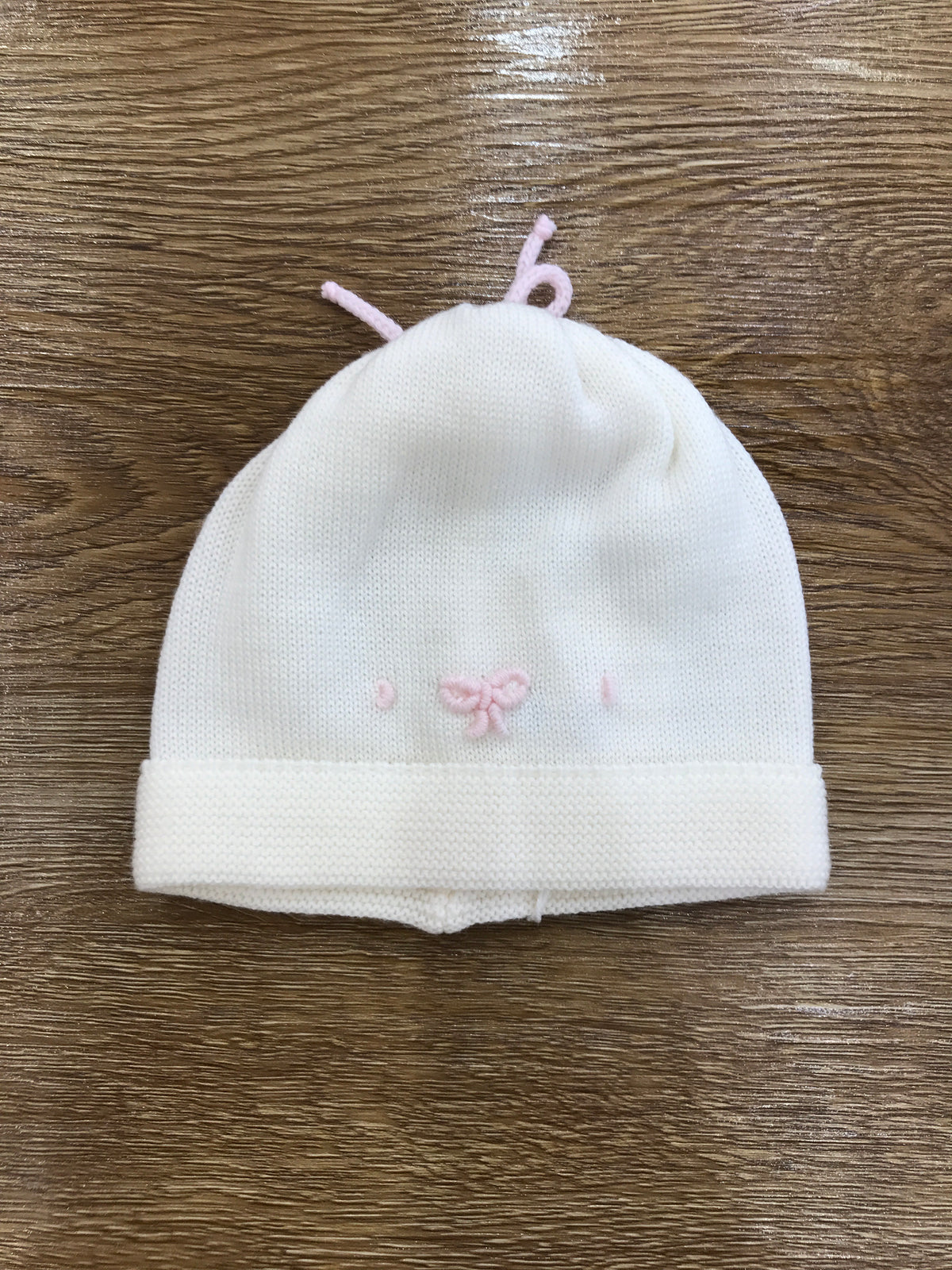 Cappello Baby Lord in lana panna con fiocchetto rosa