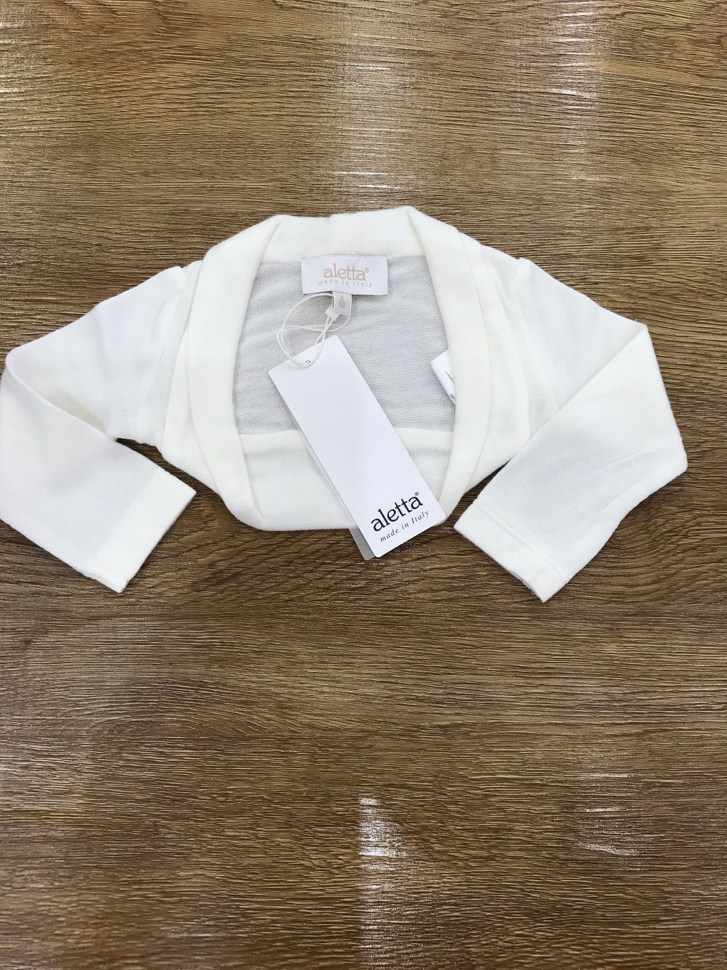 Cardigan Aletta in lanetta panna con fiocchetto sul retro