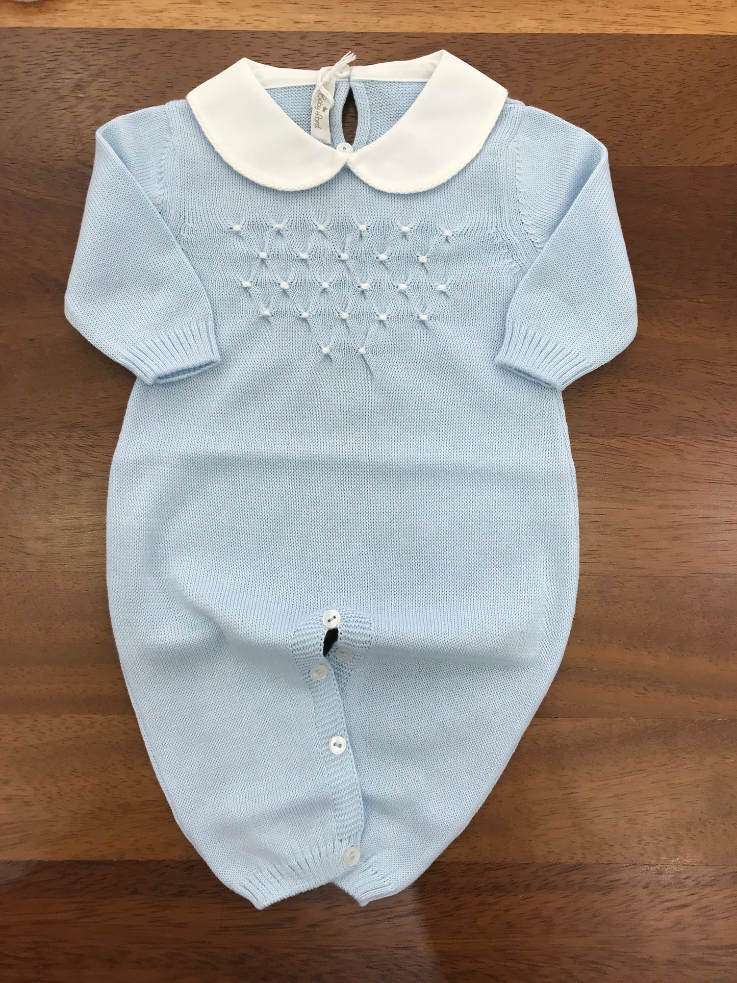 Tutina Baby Lord in filo manica lunga celeste con lavorazione di punto smock bianco sul petto