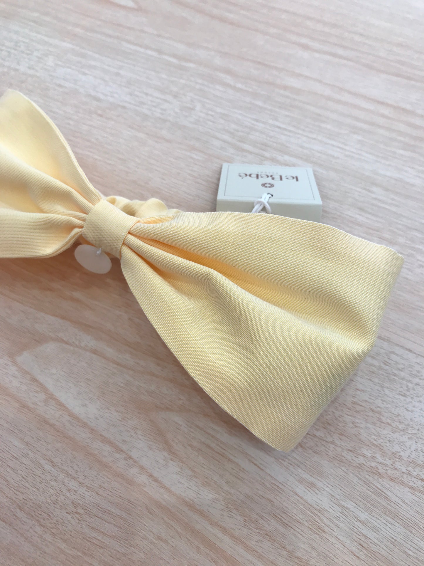 Fascia Le Bebè in cotone giallo a forma di fiocco con elastico sul retro