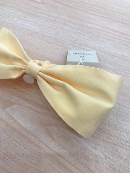 Fascia Le Bebè in cotone giallo a forma di fiocco con elastico sul retro