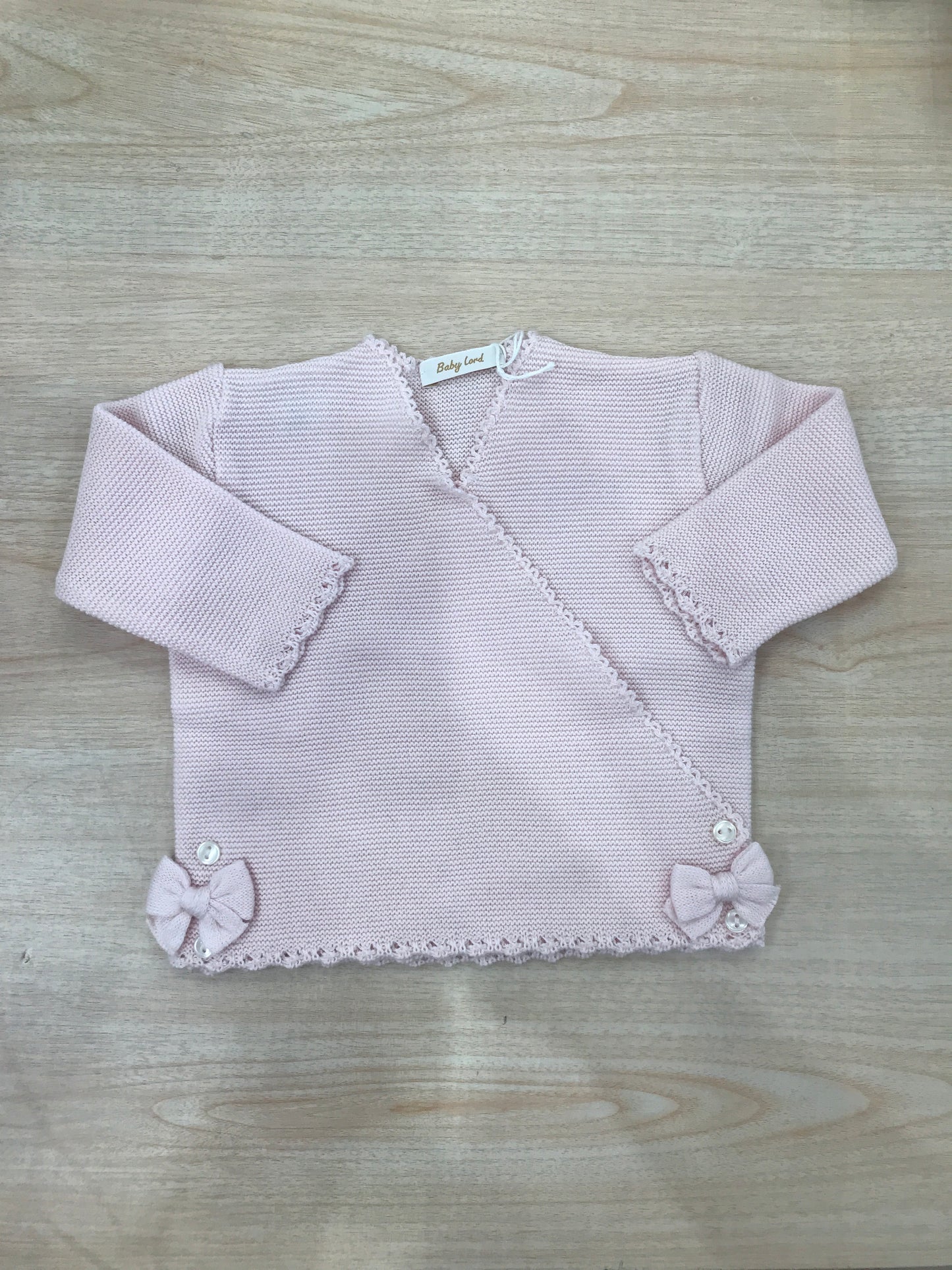 Cardigan Baby Lord in filo rosa chiusura ad incrocio con fiocchetti ai due lati