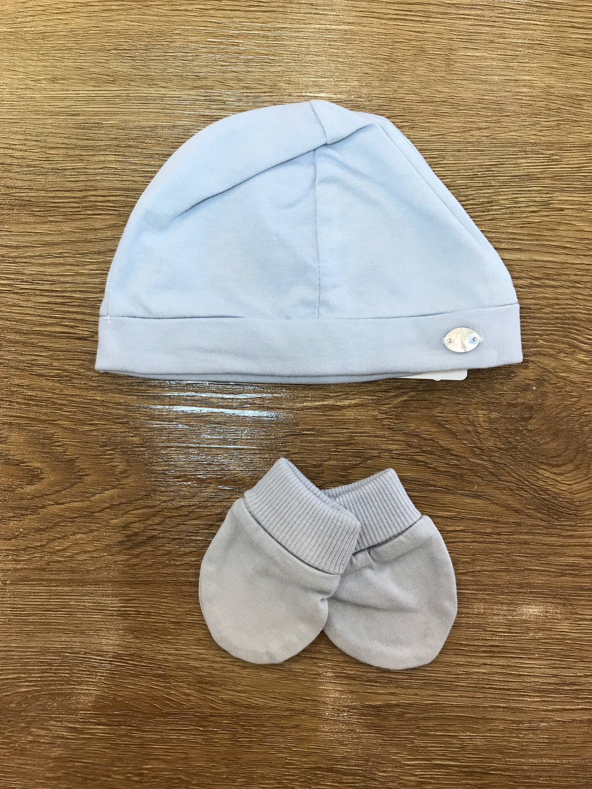 Cappello con muffole Martin Aranda in cotone celeste polvere