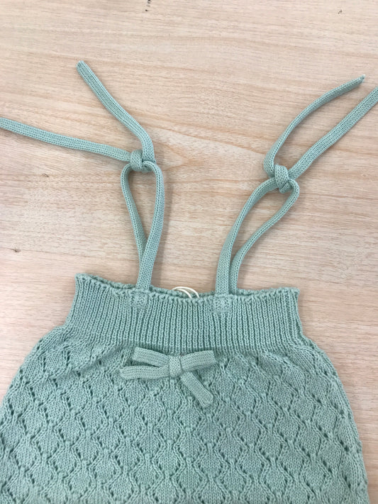 Salopette PCS in filo verde lavorata a maglia con fiocchetto sul davanti e bretelle regolabili