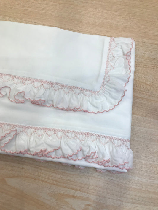 Lenzuolino Colibrì in battista di cotone bianco con rusche ai bordi rosa e lavorazione di punto smock