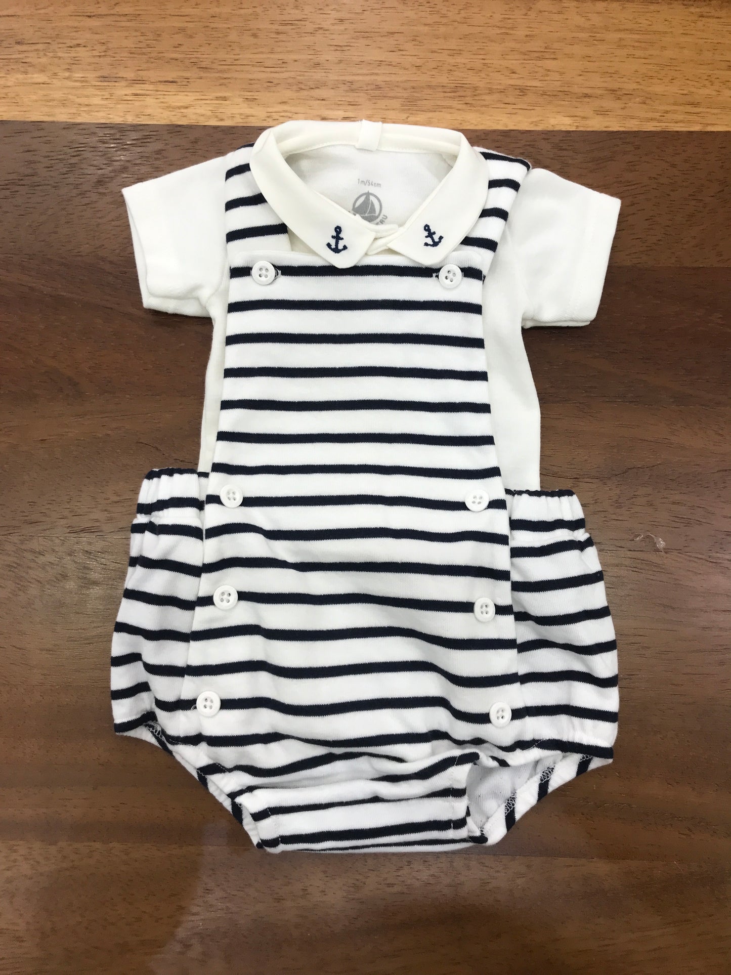 Pagliaccetto Petit Bateau in cotone a righe bianche e blu salopette on body con collo tondo con ancore ricamate