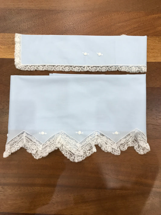 Lenzuolino Piccola Giuggiola in battista di cotone celeste con bordo a punto con pizzo e roselline ricamate