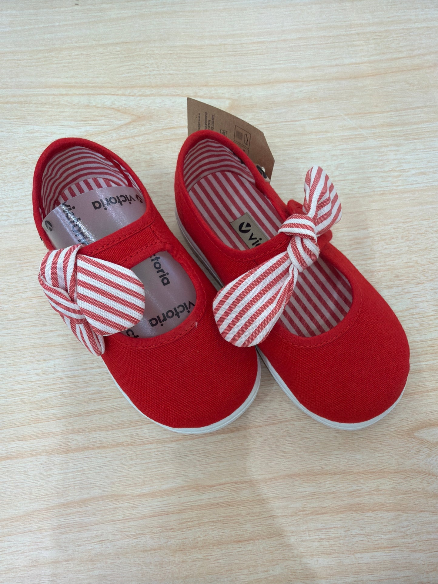 Scarpe Victoria in tela dal tono rosso con strappo e fiocco a righe sul davanti