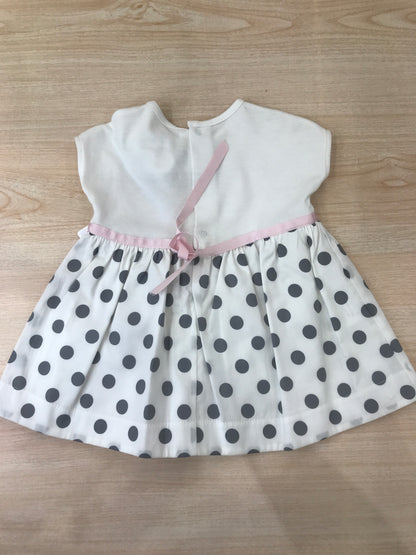 Abito Cielo Blu in cotone con gonna bianca con pois neri con fiori applicati lateralmente e fiocco rosa in vita con culotte abbinata