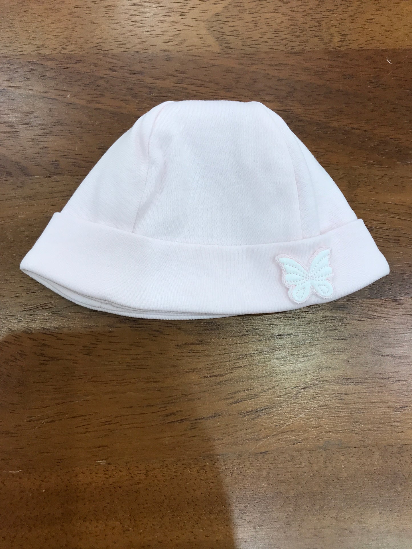 Cappello Baby Gi in cotone rosa con risvolto con farfalla applicata lateralmente