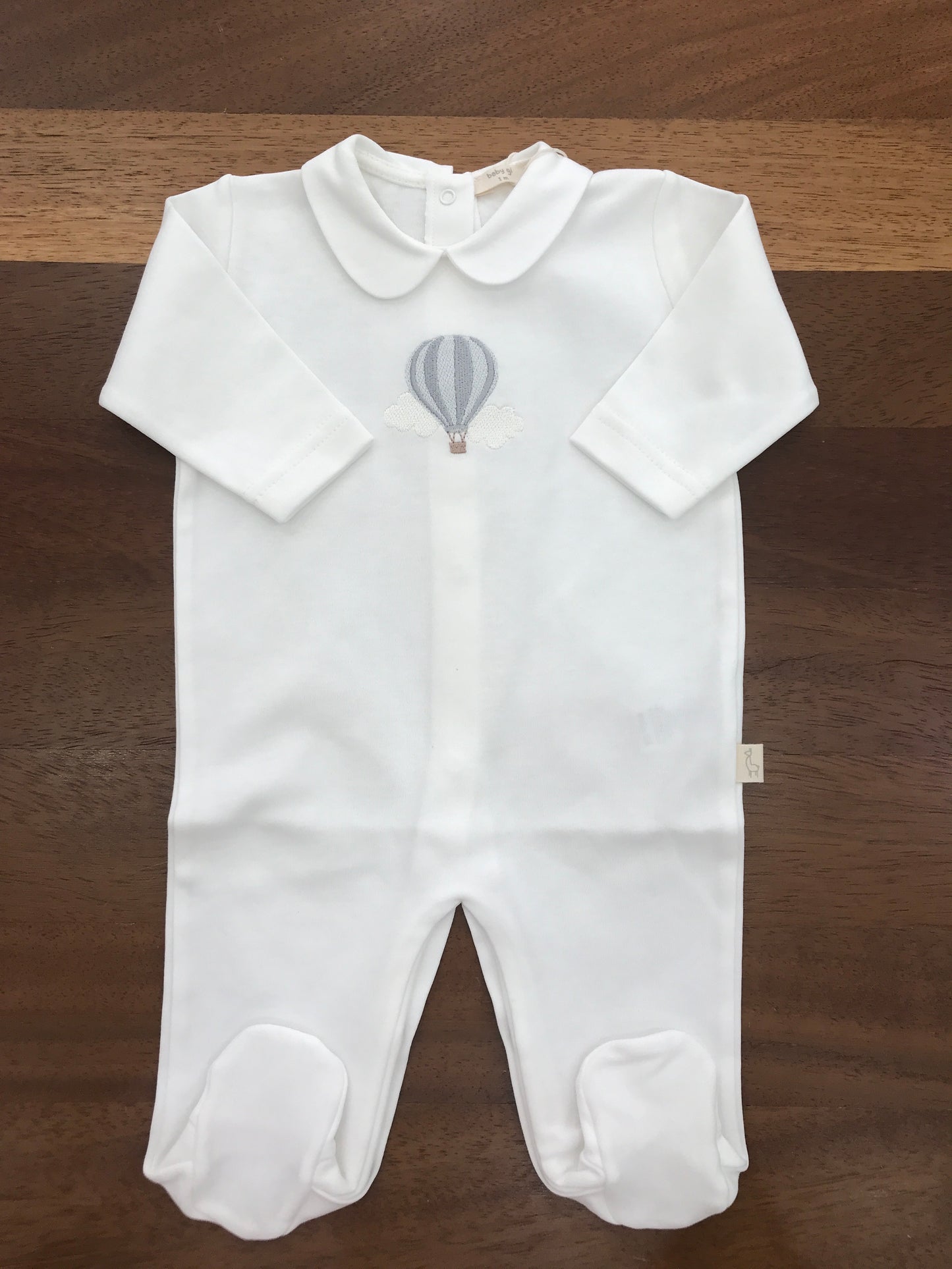 Tutina Baby Gi in cotone intera con piedini manica lunga con collo tondo bianco con mongolfiera
