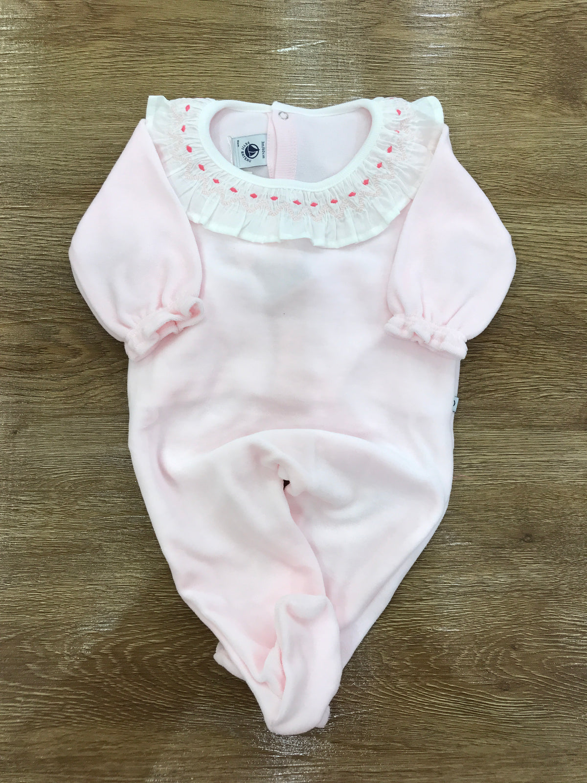 Tutina Petit Bateau in ciniglia rosa intera con collo con rusche e pois